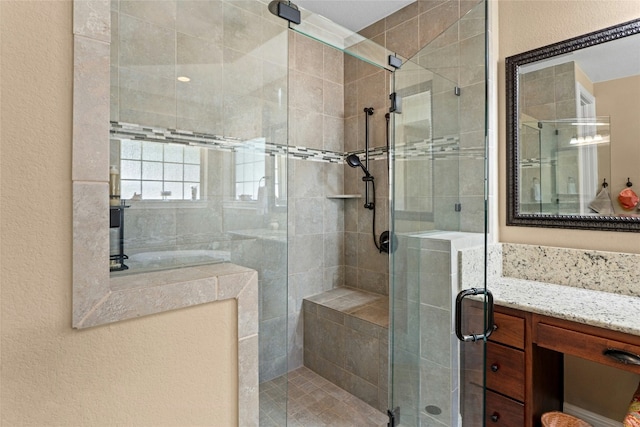 bathroom with an enclosed shower and vanity