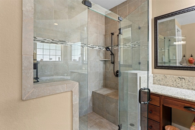 804 Laughing Dog Ct, Leander, TX 78641 - bathroom with a shower stall, vanity, and a textured wall