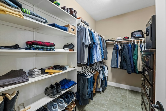 804 Laughing Dog Ct, Leander, TX 78641 - walk in closet with tile patterned flooring