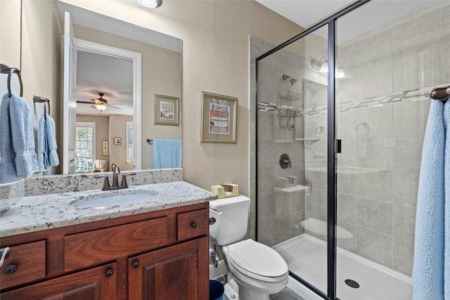 804 Laughing Dog Ct, Leander, TX 78641 - bathroom with vanity, a stall shower, a ceiling fan, and a textured wall