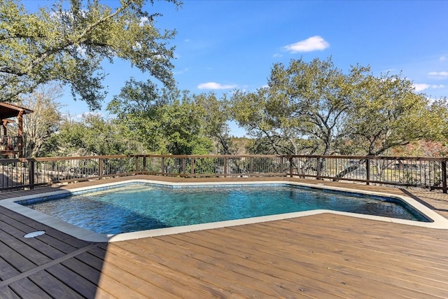 view of swimming pool featuring a deck