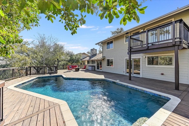 view of swimming pool with a deck