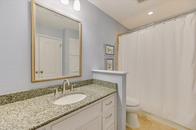 bathroom featuring vanity, tile patterned flooring, a shower with curtain, and toilet