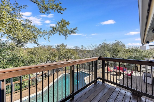 wooden terrace featuring a fenced in pool