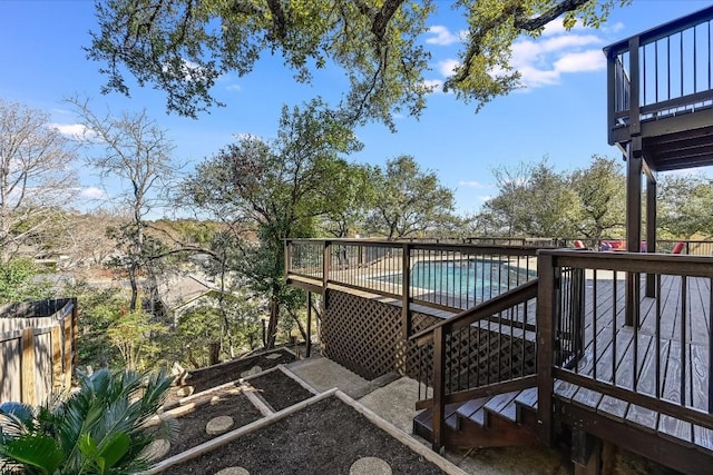 wooden deck with a fenced in pool