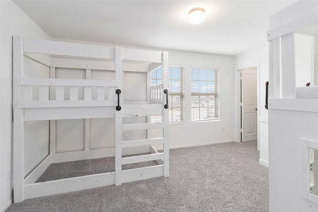 unfurnished bedroom featuring light carpet