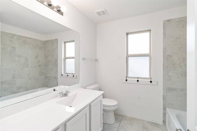 bathroom with vanity, tile patterned flooring, a wealth of natural light, and toilet