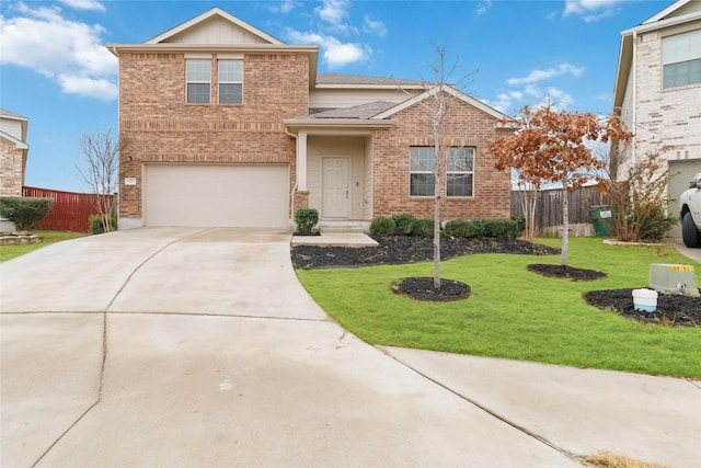 view of property with a garage and a front lawn