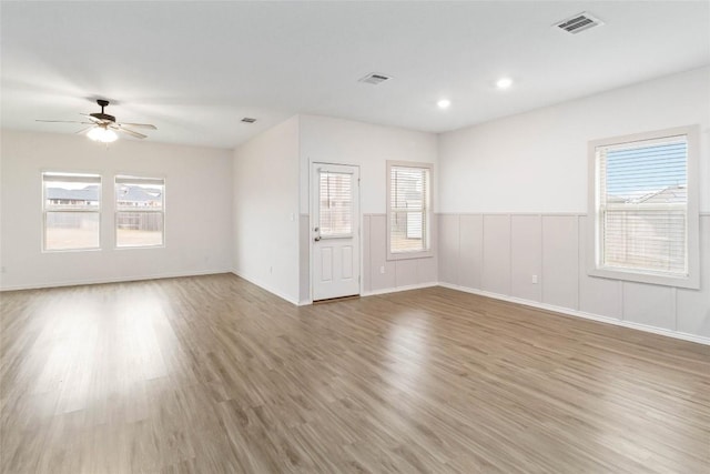 spare room with hardwood / wood-style floors and ceiling fan