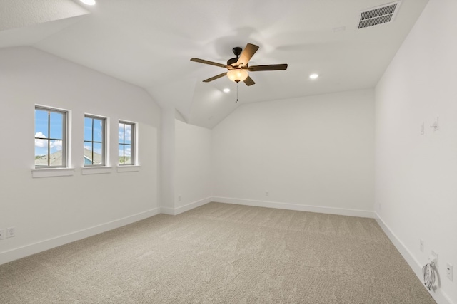 unfurnished room with ceiling fan, lofted ceiling, and carpet floors