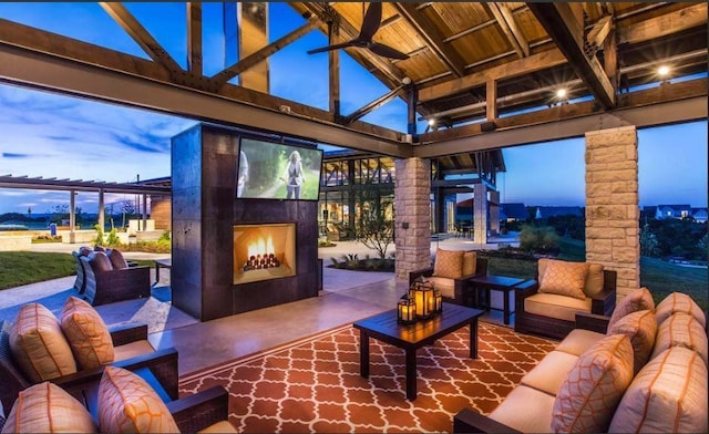 patio terrace at dusk featuring an outdoor living space with a fireplace