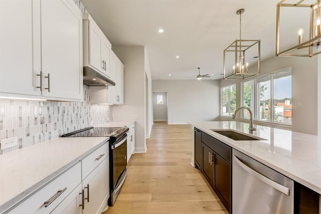 kitchen with electric range oven, pendant lighting, white cabinetry, dishwasher, and decorative backsplash