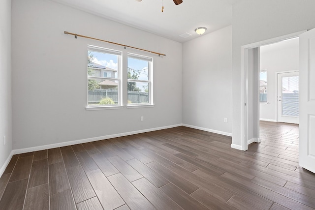 spare room featuring ceiling fan and dark hardwood / wood-style floors