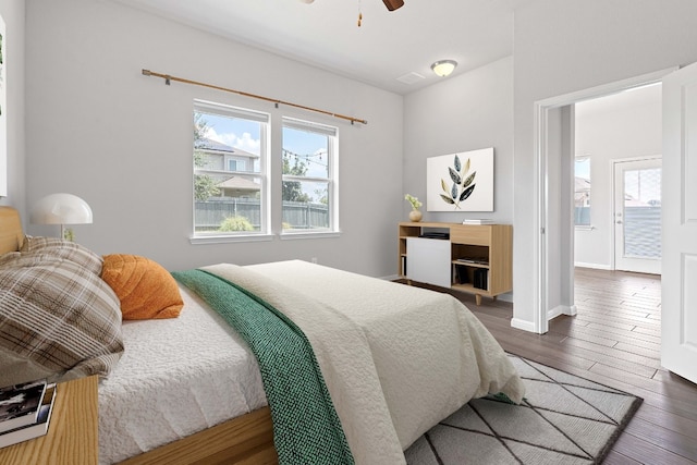 bedroom with ceiling fan and dark hardwood / wood-style flooring