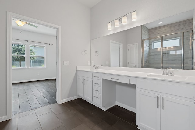 bathroom with an enclosed shower, vanity, and ceiling fan