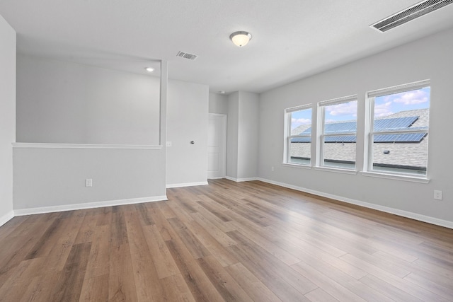 empty room with light hardwood / wood-style floors