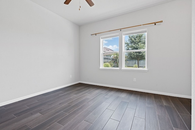 empty room with dark hardwood / wood-style flooring and ceiling fan