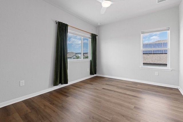 spare room featuring hardwood / wood-style flooring and ceiling fan