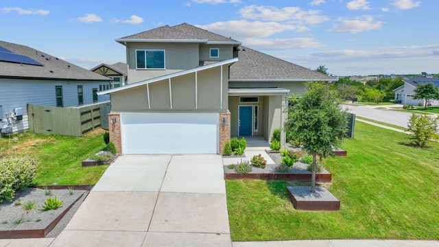 view of front of home with a garage and a front lawn