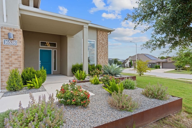 entrance to property with a lawn