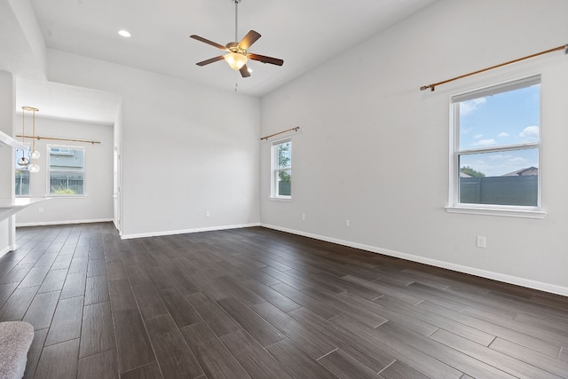 empty room featuring ceiling fan and dark hardwood / wood-style flooring