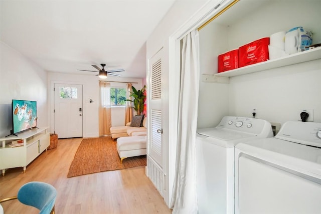 clothes washing area featuring hardwood / wood-style flooring, ceiling fan, and independent washer and dryer