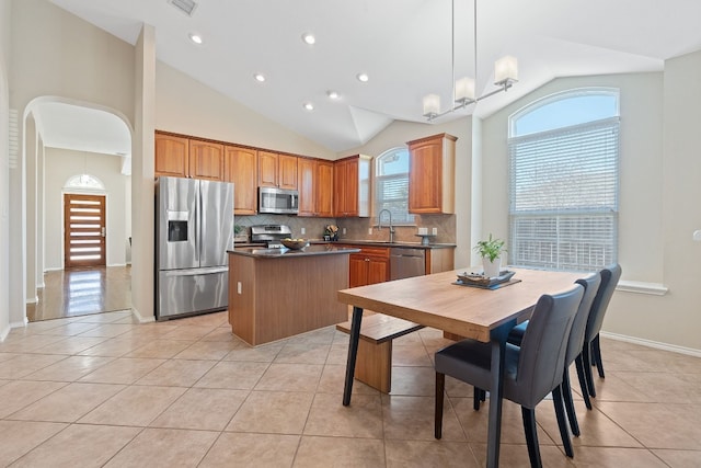 kitchen featuring stainless steel appliances, a center island, and light tile patterned floors