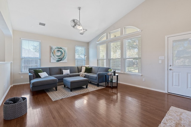 living room featuring dark hardwood / wood-style floors and high vaulted ceiling