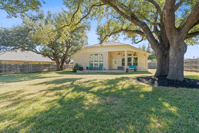 back of house featuring a patio, ceiling fan, and a lawn