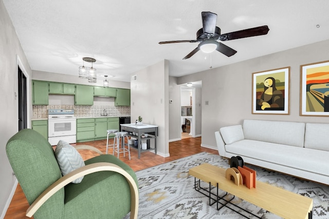 living room with sink and ceiling fan