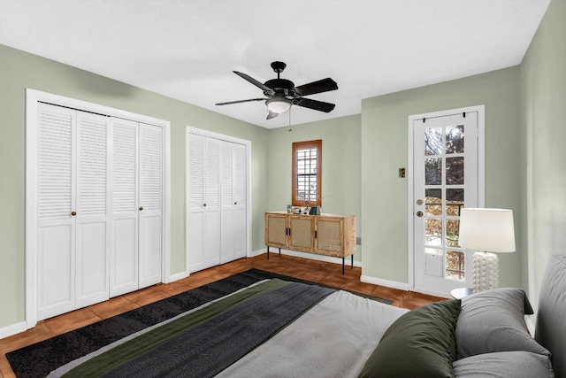 bedroom with two closets and ceiling fan