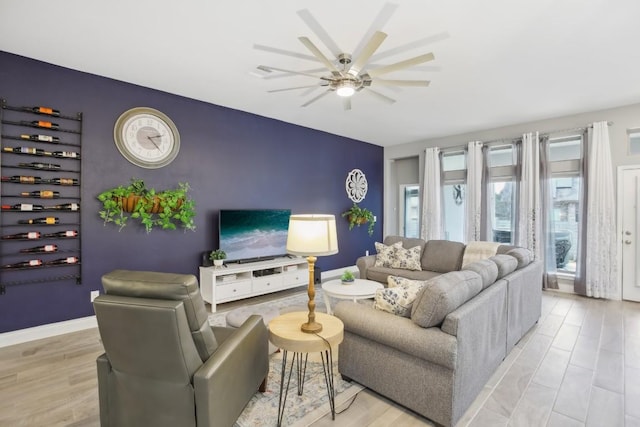 living room with ceiling fan and light wood-type flooring