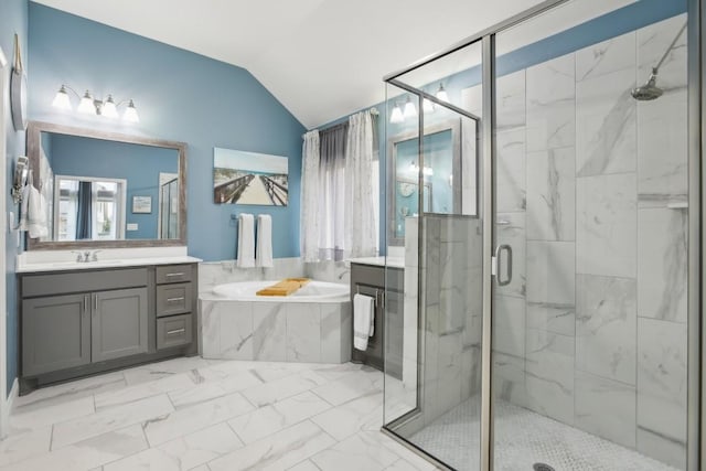 bathroom with vanity, shower with separate bathtub, and vaulted ceiling