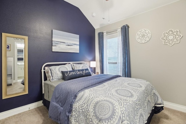 bedroom featuring lofted ceiling, baseboards, and carpet flooring