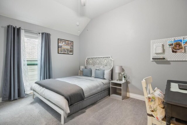 carpeted bedroom with ceiling fan and vaulted ceiling