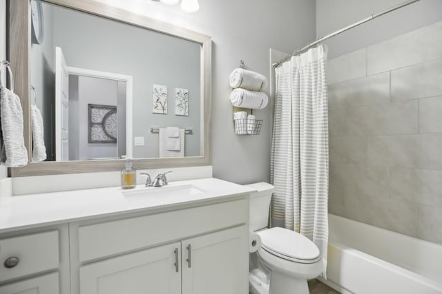 bathroom with shower / bathtub combination with curtain, vanity, and toilet