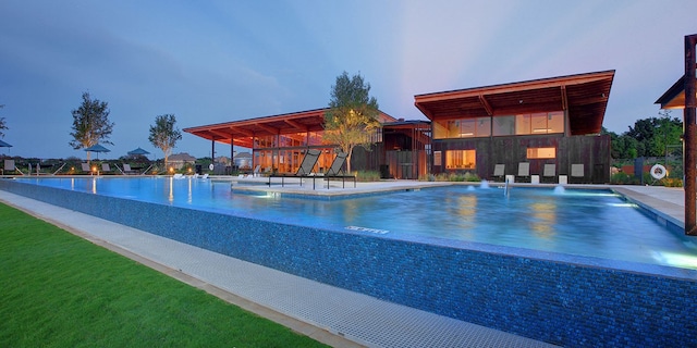 view of pool at dusk