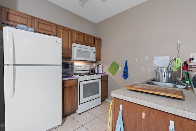 kitchen with light tile patterned floors and white appliances