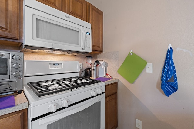 kitchen with white appliances and decorative backsplash