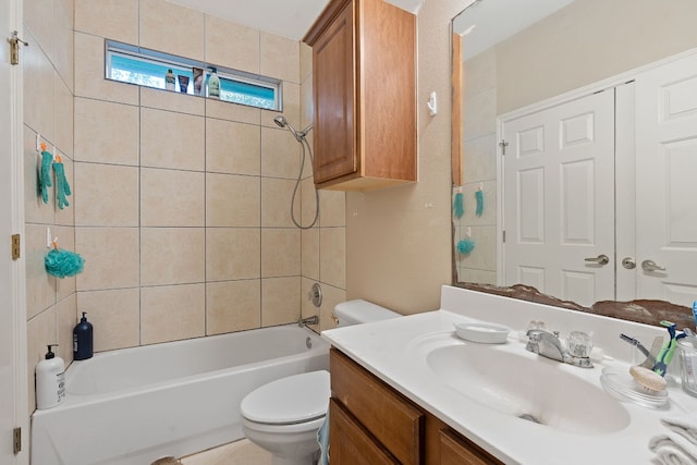 full bathroom featuring tiled shower / bath combo, vanity, and toilet