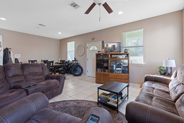 tiled living room with ceiling fan