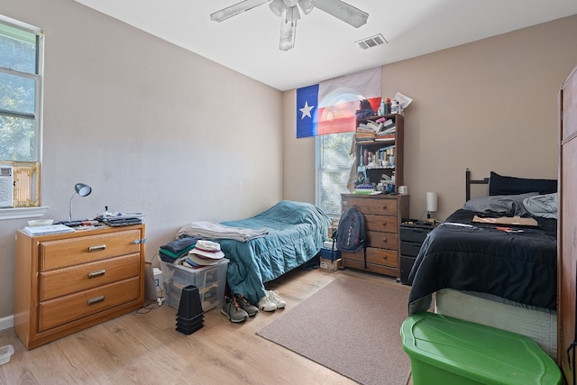 bedroom with ceiling fan and light hardwood / wood-style flooring