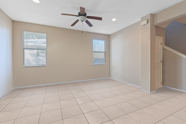 spare room with ceiling fan and a wealth of natural light