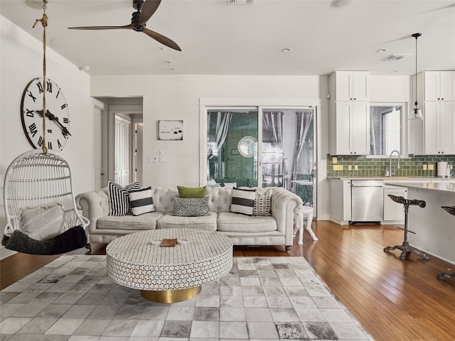 living room featuring ceiling fan and wood-type flooring