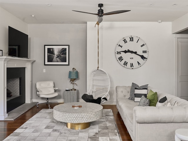 living room with hardwood / wood-style flooring and ceiling fan