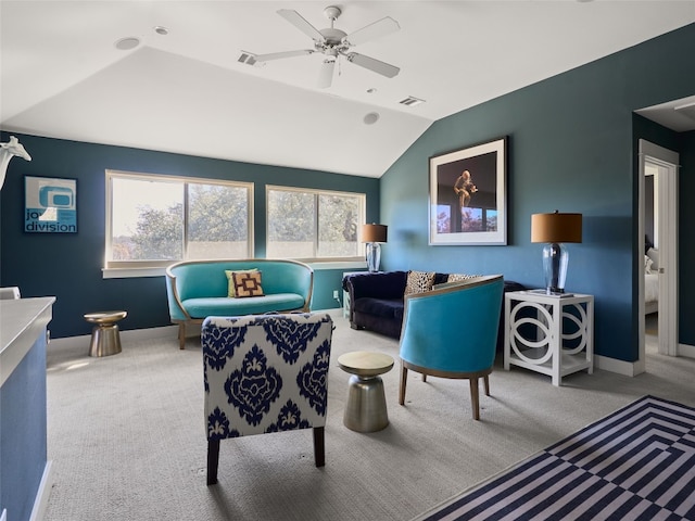 living room with vaulted ceiling, light colored carpet, and ceiling fan