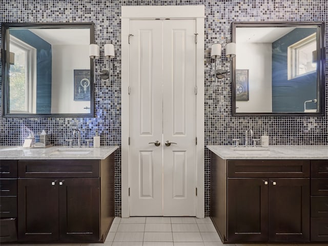 bathroom featuring vanity, tile walls, tile patterned floors, and decorative backsplash