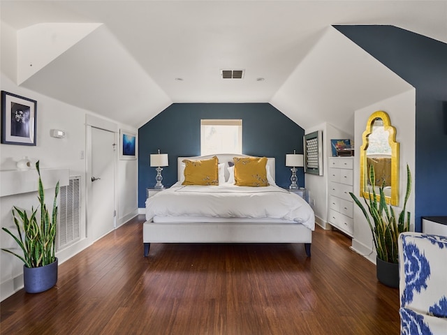 bedroom featuring lofted ceiling and dark hardwood / wood-style floors