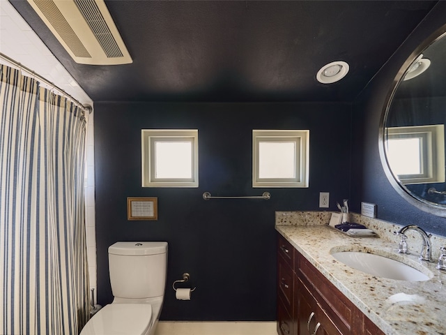 bathroom with vanity and toilet