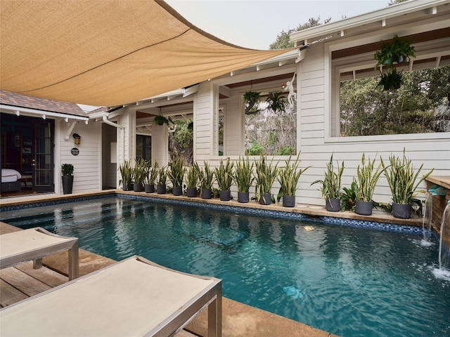 view of swimming pool with pool water feature